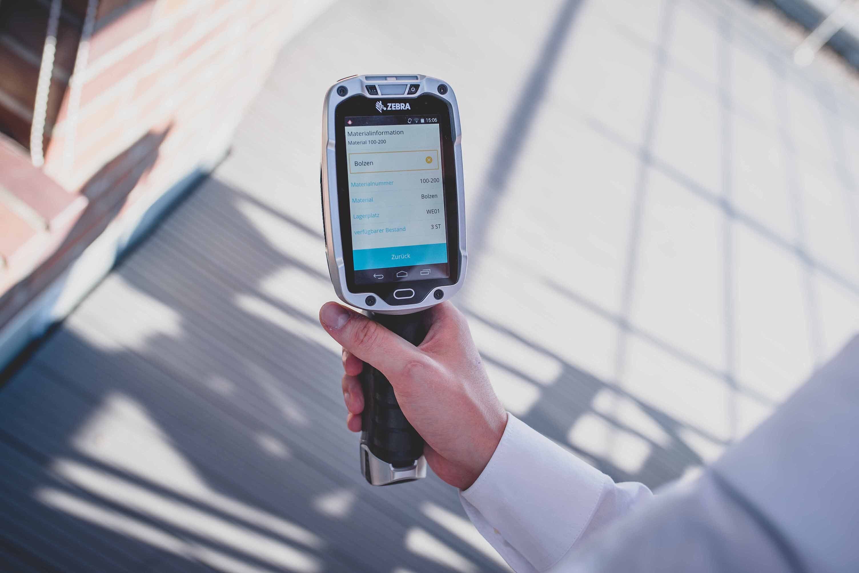 Employees holding handheld device to use mobile SAP App